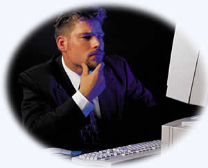 man sitting at computer and thinking.
